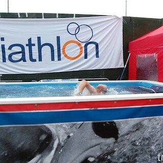picture of a triathlete swim with the Endless Pools swim current at a UK triathlon expo
