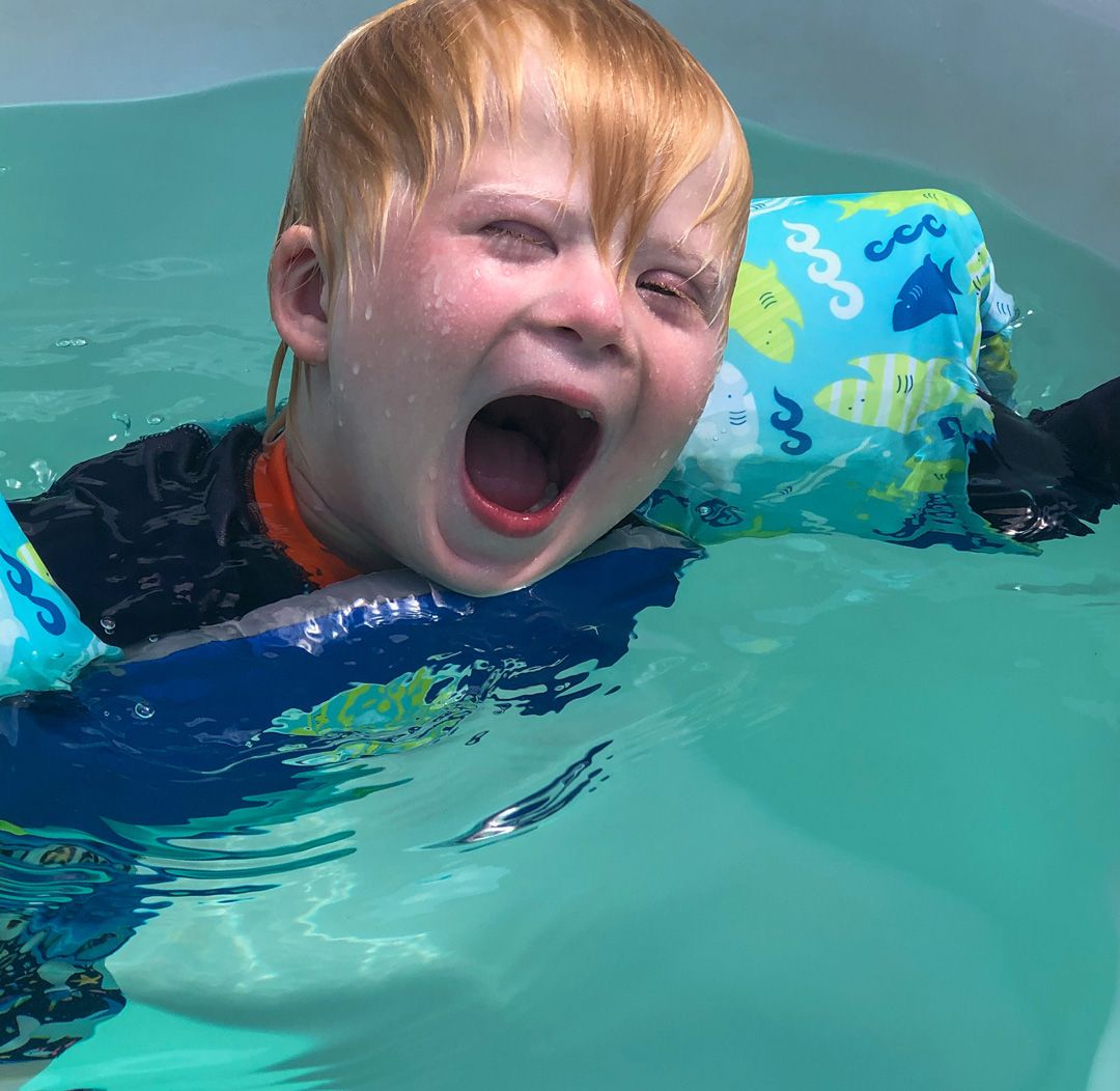 picture of boy with autism enjoying activity and therapy in an Endless Pools swim spa